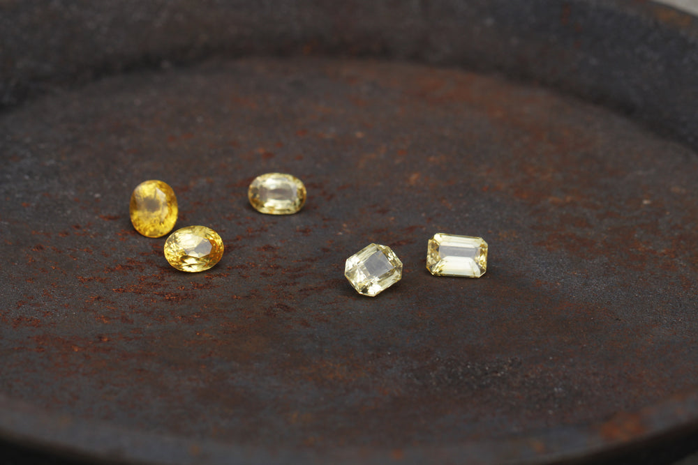Natural yellow sapphires (Pukhraj) on a dark plate